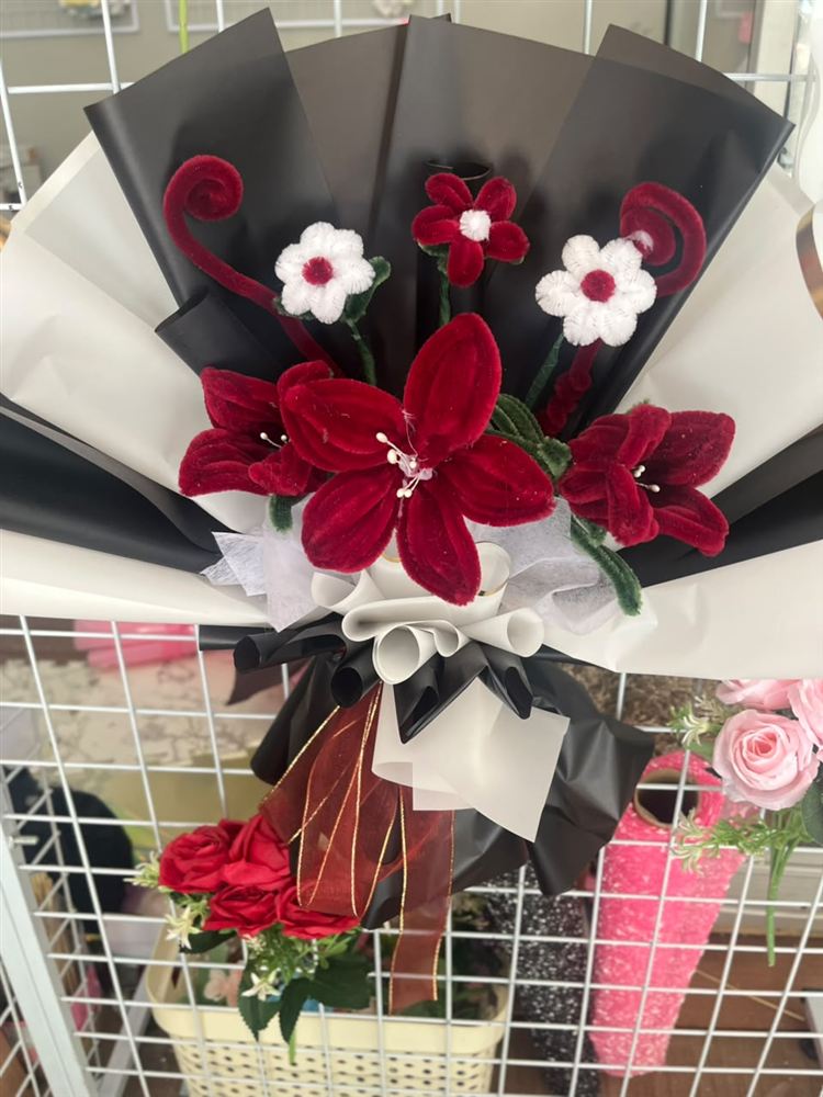 Buket bunga merah dengan pembungkus hitam putih